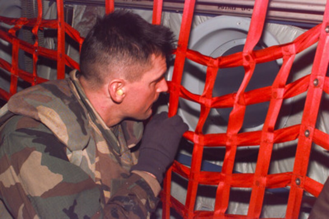 A U.S. Army soldier from the 3rd Battalion, 10th Special Forces, Fort Carson, Colo., gets his first look at the Bosnian countryside from the window of a U.S. Air Force C-130 Hercules during the plane's approach into Sarajevo, Bosnia and Herzegovina, on Dec. 18, 1995. Soldiers are deploying to Sarajevo to support the NATO Enabling Force of Operation Joint Endeavor. Enabling forces are moving into the Croatia, Bosnia and Herzegovina, and Slovenia theaters of operation to prepare entry points for the main Implementation Force. 