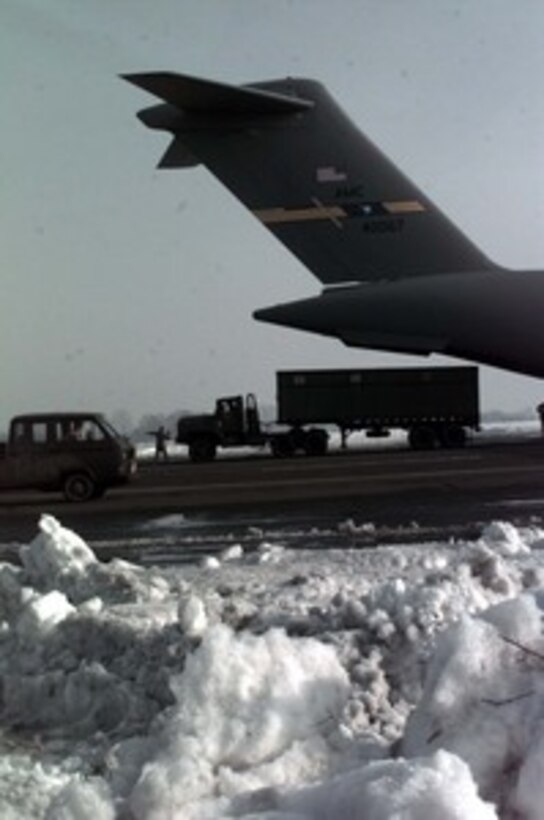 A 5 ton tractor-trailer is driven off a U.S. Air Force C-17A Globemaster III at Taszar Air Field near Kaposvar, Hungary, on Dec. 19, 1995. The Globemaster III crew is flying in a cargo of 5 ton trucks from Rhein Main Air Base, Germany, to support the NATO Enabling Force of Operation Joint Endeavor. Enabling forces are moving into the Croatia, Bosnia and Herzegovina, and Slovenia theaters of operation to prepare entry points for the main Implementation Force. The Globemaster III is from the 14th Airlift Squadron, 437th Airlift Wing, Charleston Air Force Base, S.C. 