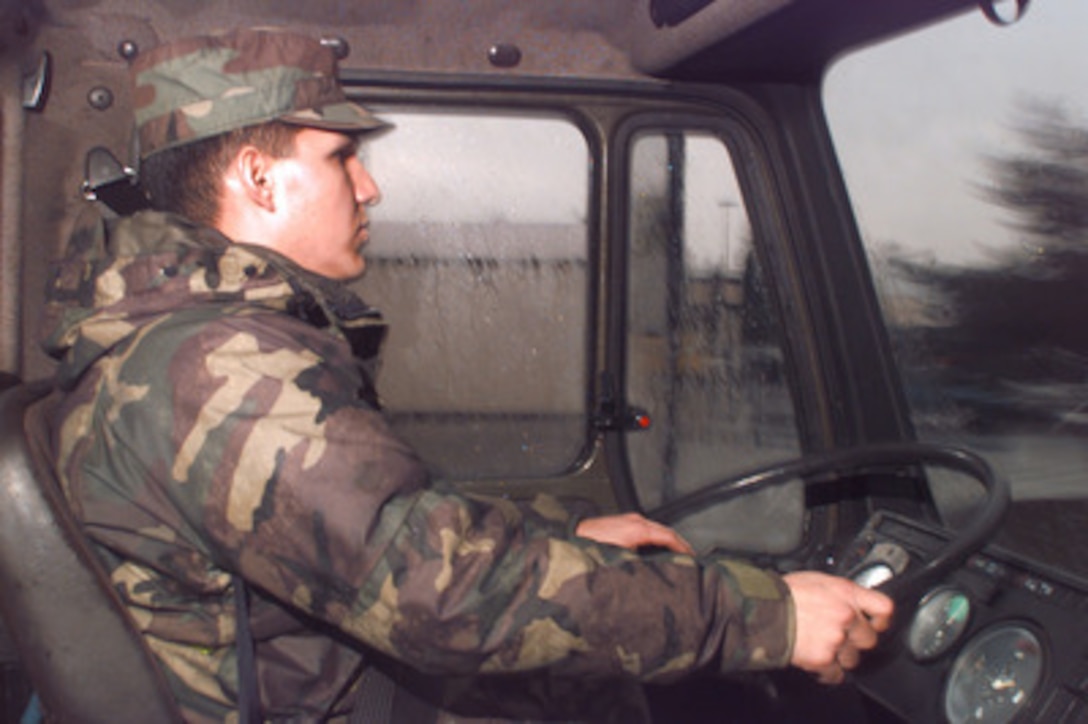 U.S. Air Force Senior Airman John Gonzales drives a 40 foot flatbed truck to the Air Mobility Command air terminal at Ramstein Air Base, Germany, to pick up a load of military equipment on Dec. 21, 1995. Gonzales will deliver the equipment to a marshaling yard where it will be given a chalk number and await transportation. Equipment from all over the world is arriving at Ramstein to be staged for deployment to Bosnia and Herzegovina where it will be used by the NATO Implementation Force (IFOR). Gonzales is attached to the 86th Transportation Squadron at Ramstein. 