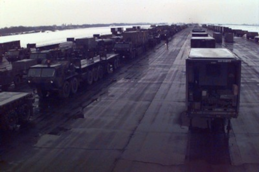 U.S. Army vehicles of all shapes, sizes and capacities are parked in rows at Taszar Air Base near Kaposvar, Hungary, on Dec. 22, 1995, during Operation Joint Endeavor. The vehicles are being unloaded from rail cars by Reception, Staging, Onward movement and Integration or RSOI forces who are working at theater of operations entry points to support the NATO Implementation Force (IFOR) in Bosnia and Herzegovina. 