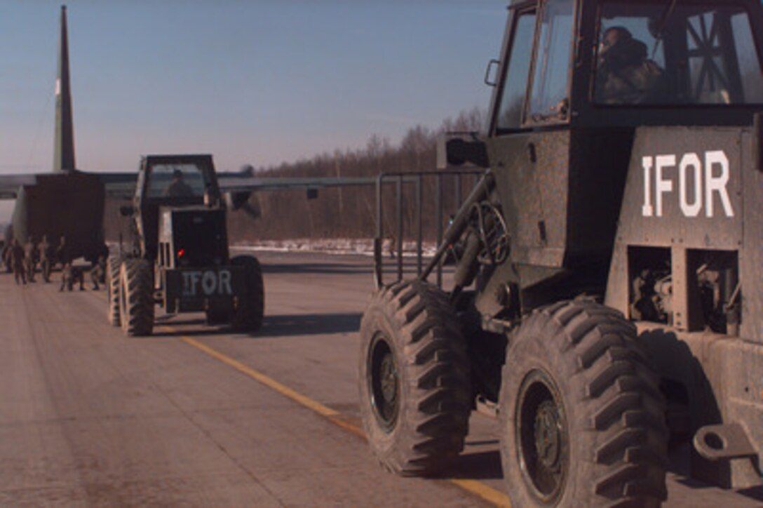NATO Implementation Force (IFOR) forklifts line up to quickly unload a U.S. Air Force C-130 Hercules at Tuzla Air Base, Bosnia and Herzegovina, on Dec. 22, 1995, in support of the NATO's Operation Joint Endeavor. Reception, Staging, Onward movement and Integration or RSOI forces are working at theater of operations entry points to support the NATO Implementation Force in Bosnia and Herzegovina. 