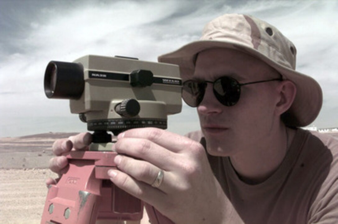 U.S. Air Force Senior Airman Paul A. Loede Jr., a Engineer Assistant from the 1st Civil Engineering Squadron, Langley Air Force Base, Va., uses an auto level to check distances at a Jordanian Air Force Base on April 1, 1996. The 1st Civil Engineering Squadron will erect a small tent city to support a U.S. Air Force Air Power Expeditionary Force which will operate out of Jordan. The Expeditionary Force will provide additional land-based air forces to augment regional assets. The deployment will also give the Air Force an opportunity to work and train with coalition partners in the region. The deployment should be completed near the end of June 1996. Loede is from Cleveland, Ohio. 