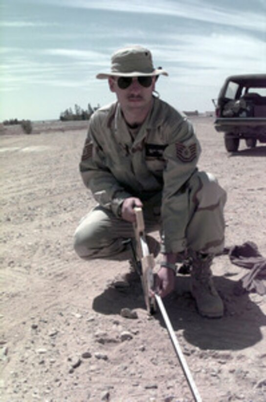 Tech. Sgt. William C. Young plots tent sites at a Jordanian Air Force Base on April 1, 1996. The 1st Civil Engineering Squadron will erect a small tent city to support a U.S. Air Force Air Power Expeditionary Force which will operate out of Jordan. The Expeditionary Force will provide additional land-based air forces to augment regional assets. The deployment will also give the Air Force an opportunity to work and train with coalition partners in the region. The deployment should be completed near the end of June 1996. Young is from Niagara Falls, N.Y. 