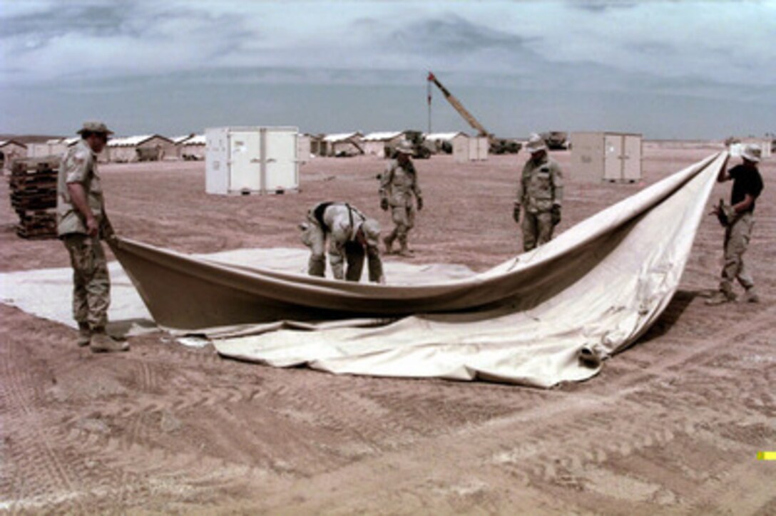 U.S. Air Force personnel from the 5th Combat Communications Group erect a tent on April 1, 1996, at the site of where a small tent city will be built to support a U.S. Air Force Air Power Expeditionary Force which will operate out of Jordan. The Expeditionary Force will provide additional land-based air forces to augment regional assets. The deployment will also give the Air Force an opportunity to work and train with coalition partners in the region. The deployment should be completed near the end of June 1996. The 5th is deployed from Robins Air Force Base, Ga. 