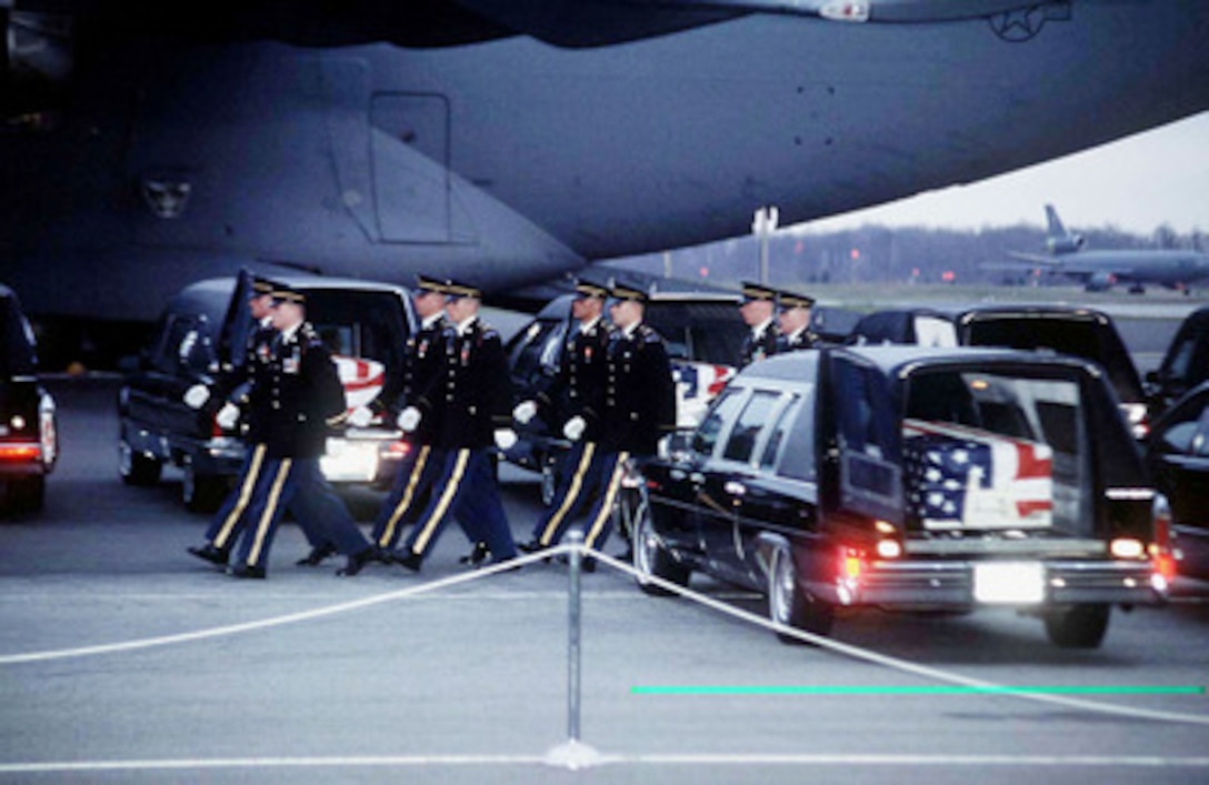 Members of the Joint Ceremonial Honor Guard march off after carrying the remains of Commerce Secretary Ron Brown and other members of the Commerce mission to Bosnia and Herzegovina who were killed in a plane crash near Dubrovnik, Croatia, on April 3 to waiting hearses at Dover Air Force Base, Del., on April 6, 1996. 