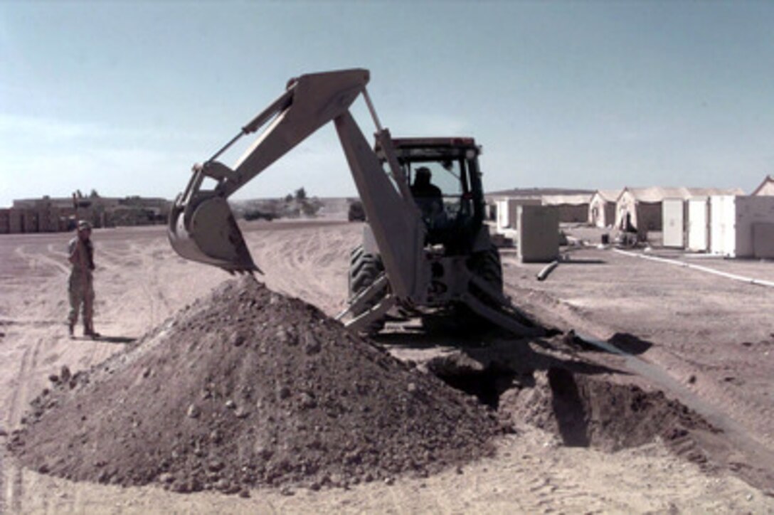 Engineers from the U.S. Air Force 9th Civil Engineering Squadron use a backhoe to dig a ditch for a lift station on a Jordanian Air Base on April 4, 1996. Engineering squadrons are building a small tent city to support a U.S. Air Force Air Power Expeditionary Force which will operate out of Jordan. The Expeditionary Force will provide additional land-based air forces to augment regional assets. The deployment will also give the Air Force an opportunity to work and train with coalition partners in the region. The deployment should be completed near the end of June 1996. The 9th Civil is deployed from Beale Air Force Base, Calif. 