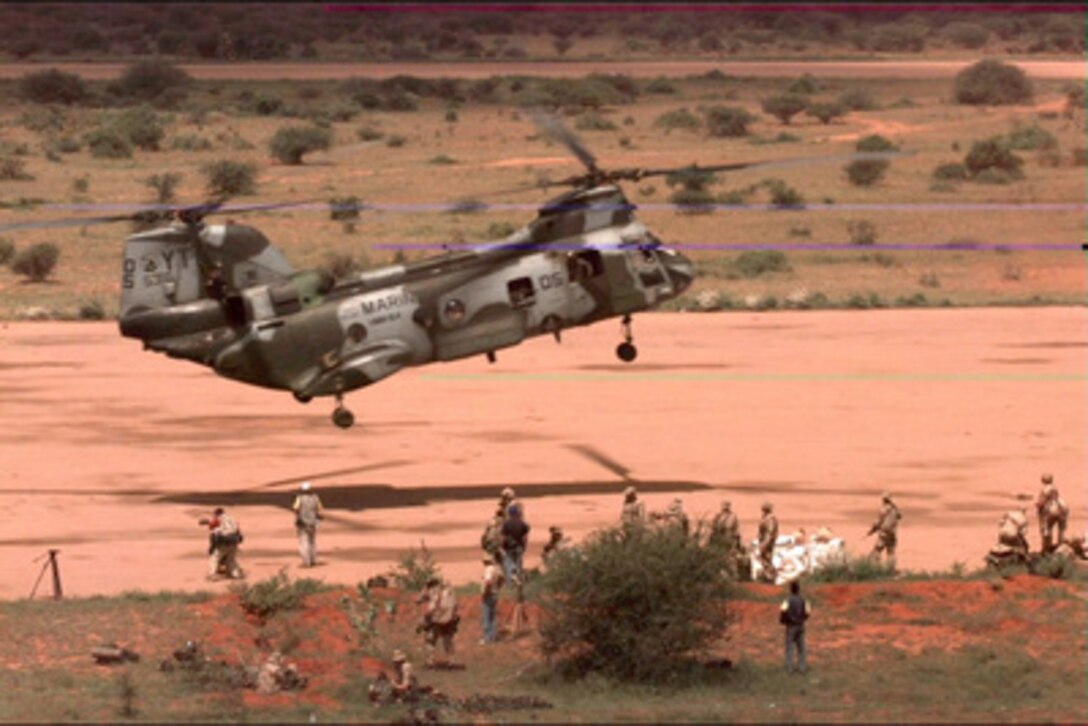 U.S. Marine Corps CH-46 Sea Knight helicopters, like this one shown in a file photo operating in Somalia, are embarked onboard the amphibious assault ship USS Guam (LPH 9). President Clinton has ordered the Guam to steam towards the coast of Liberia to assist in the evacuation of U.S. citizens and foreign nationals known as Operation Assured Response. Joining the Guam will be the amphibious transport dock ship USS Trenton (LPD 14) and the dock landing ship USS Portland (LSD 37). All three ships are designed to support amphibious operations via helicopters or landing craft. The Guam also carries a complement of Marine CH-53 Sea Stallion helicopters. 