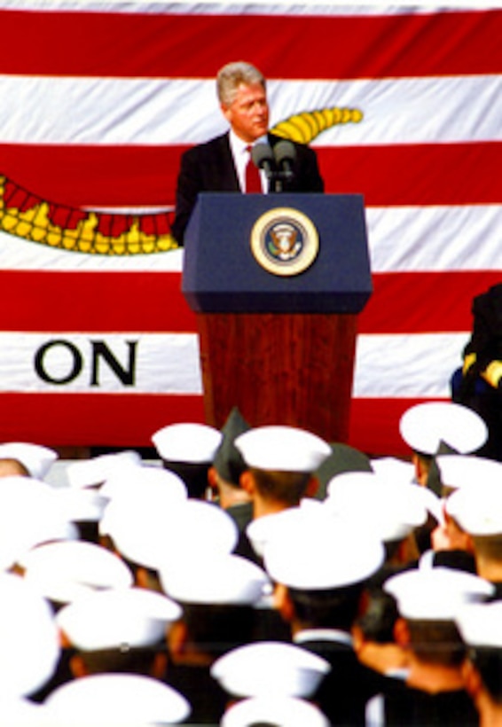 With a "Don't Tread on Me" flag for a backdrop President Bill Clinton addresses U. S. Armed Forces personnel on the flight deck of the U.S. Navy aircraft carrier USS Independence (CV 62) at her homeport of Yokosuka, Japan, on Wednesday, April 17, 1996. The President took time out from his state visit to Japan to meet with the crew of the carrier and to thank them for their role in representing U.S. interests during their deployment off the coast of Taiwan. As the oldest commissioned ship in active service, the Independence is permitted to fly the "Don't Tread on Me" flag. 