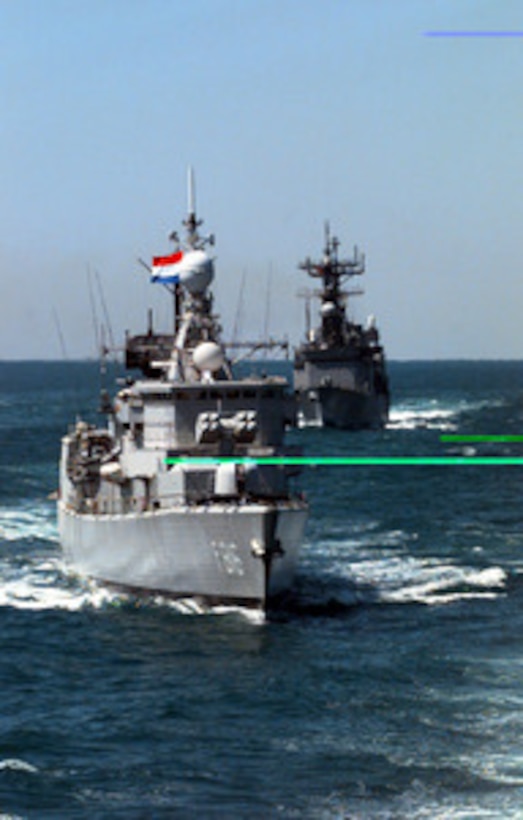 The Royal Netherlands ship HrMs Abraham Crijnssen (F 816) maneuvers across the bow of the USS Nicholson (DD 982) as they steam in formation off the coast of Florida on March 23, 1996. The two ships are part of an armada from seven NATO nations participating in Exercise Unified Spirit '96. The combined exercise is designed to improve the readiness and effectiveness of NATO forces in the areas of command communication, embargo enforcement, freedom of navigation and protection and coordination with mine warfare forces. 