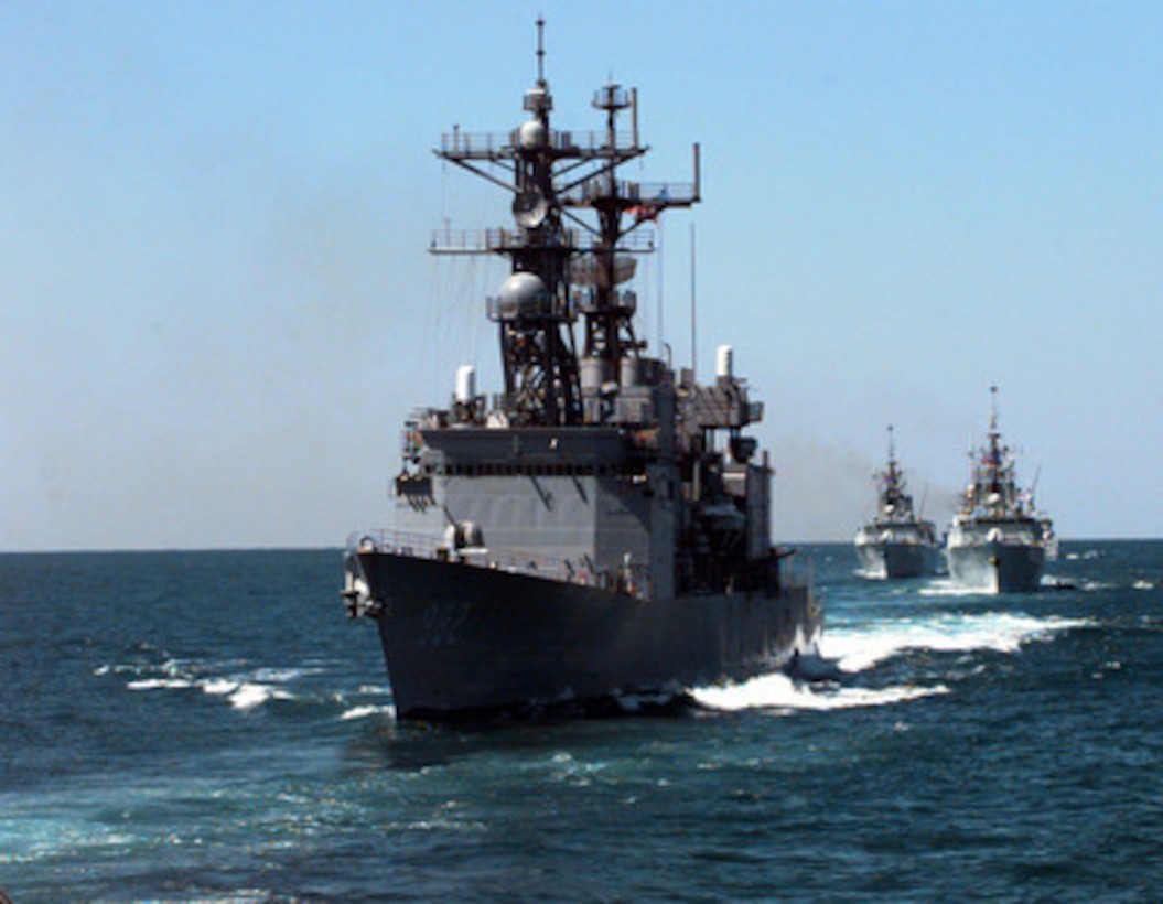 The USS Nicholson (DD 982) maneuvers across the bow of three Canadian destroyers as they steam in formation off the coast of Florida on March 23, 1996. The ships are part of an armada from seven NATO nations participating in Exercise Unified Spirit '96. The combined exercise is designed to improve the readiness and effectiveness of NATO forces in the areas of command communication, embargo enforcement, freedom of navigation and protection and coordination with mine warfare forces. 