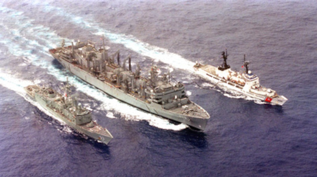 Pacific Ocean (June 7, 1996). . . .The fast combat stores ship USS Rainier (AOE 7) demonstrates its ability to deliver the goods in a multiple-ship underway replenishment exercise on June 7, 1996, with the Australian frigate HMAS Sydney (FFG 03) and USCGC Sherman (WHEC 720) near the Hawaiian islands as part of RIMPAC '96. 