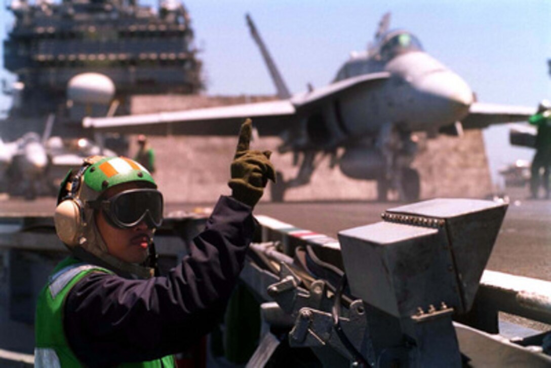 On board the aircraft carrier USS Constellation (CV 64) in the Southern California operating area, Aviation Boatswain's Mate Equipmentman First Class Victor Navarro gives the standby signal prior to the launch of an F/A-18 Hornet on the number one catapult. 