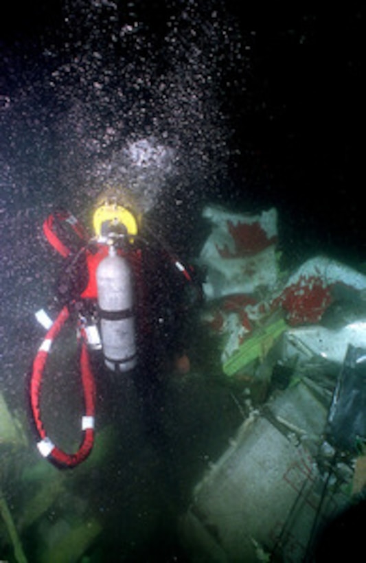 Diver walks on the bottom amid TWA Flight 800 debris