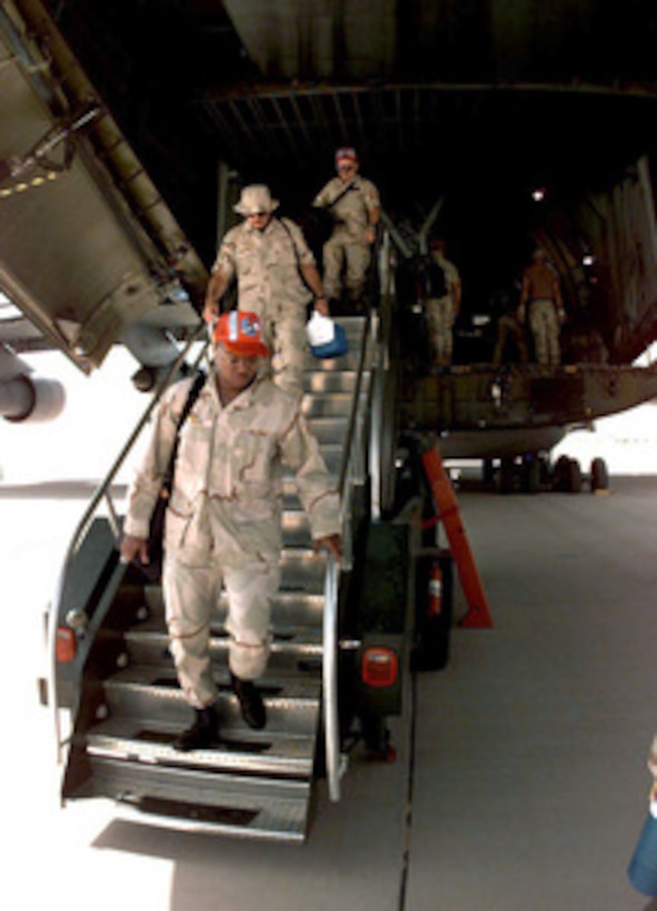 U.S. Air Force engineers from the 823rd Red Horse Squadron step off of a C-5B Galaxy at Prince Sultan Air Base at Al Kharj, Saudi Arabia, on August 7, 1996. The Galaxy is bringing in engineers, equipment and supplies to construct a tent city to house U.S. personnel conducting Operation Southern Watch. Nearly 4,000 personnel, aircraft, and equipment are being moved from bases in Dhahran and Riyadh to the remote desert air base to reduce their vulnerability to terrorist attack. Southern Watch is the U.S. and coalition enforcement of the no-fly-zone over Southern Iraq. The 823rd Red Horse is from Hurlburt Field, Fla. 
