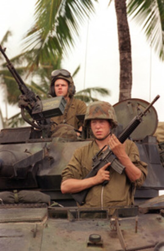 Lance Cpl. Ryan Roth keeps a steady hand on his M-16A2 rifle as Cpl. Mike Gaffey mans an M-240G machine gun while they stand watch in their Light Armored Vehicle during a simulated Noncombatant Evacuation Operation on June 11, 1996, at Kaneohe Bay Marine Corps Station, Hawaii, as part of exercise RIMPAC '96. More than 44 ships, 200 aircraft and 30,000 soldiers, sailors, Marines, airmen and Coast Guardsmen are involved in the exercise. The purpose of RIMPAC '96 is to improve coordination and interoperability of combined and joint forces in maritime tactical and theater operations. Australia, Canada, Chile, Japan, the Republic of Korea and the U.S. are participating in the exercise. 