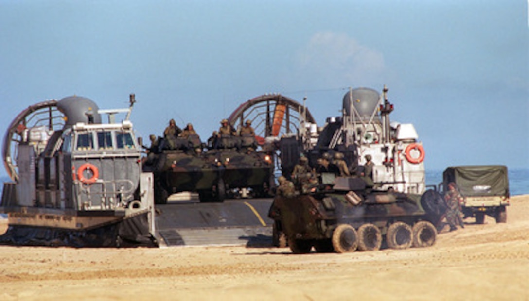 U.S. Marine Corps Humvees and Light Armored Vehicles roll off the deck of a U.S. Navy Landing Craft Air Cushion during an amphibious landing on June 15, 1996, as part of RIMPAC '96. The amphibious assault at Pacific Missile Range Facility, Barking Sands, Hawaii, is being conducted by 11th Marine Expeditionary Unit, Camp Pendleton, Calif., and involves Navy and Marine air, ground and sea forces for training as a combined amphibious assault force. More than 44 ships, 200 aircraft and 30,000 soldiers, sailors, Marines, airmen and Coast Guardsmen are involved in the exercise. The purpose of RIMPAC '96 is to improve coordination and interoperability of combined and joint forces in maritime tactical and theater operations. Australia, Canada, Chile, Japan, the Republic of Korea and the U.S. are participating in the exercise. 
