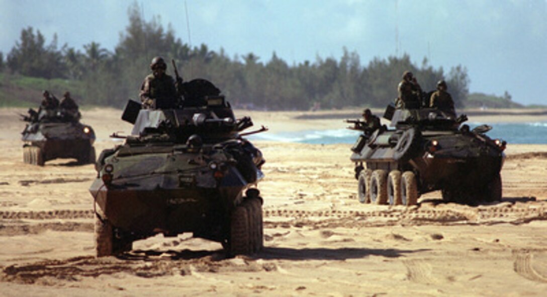 U.S. Marine Corps Light Armored Vehicles maneuver on the beach during an amphibious landing on June 15, 1996, as part of RIMPAC '96. The amphibious assault at Pacific Missile Range Facility, Barking Sands, Hawaii, is being conducted by 11th Marine Expeditionary Unit, Camp Pendleton, Calif., and involves Navy and Marine air, ground and sea forces for training as a combined amphibious assault force. More than 44 ships, 200 aircraft and 30,000 soldiers, sailors, Marines, airmen and Coast Guardsmen are involved in the exercise. The purpose of RIMPAC '96 is to improve coordination and interoperability of combined and joint forces in maritime tactical and theater operations. Australia, Canada, Chile, Japan, the Republic of Korea and the U.S. are participating in the exercise. 