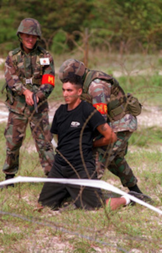 U.S. Marine Corps Military Policemen demonstrate to troops from Moldova, the Slovak Republic and other U.S. Marines, the proper techniques for a personnel search/weapons disarmament during a Situational Training Exercise at Camp Lejeune, N.C., on Aug. 17, 1996, as part of Cooperative Osprey '96. Cooperative Osprey '96 is a NATO sponsored exercise as part of the alliance's Partnership for Peace program. The aim of the exercise is to develop interoperability among the participating forces through practice in combined peacekeeping and humanitarian operations. Three NATO countries and 16 Partnership for Peace nations are taking part in the field training exercise. 
