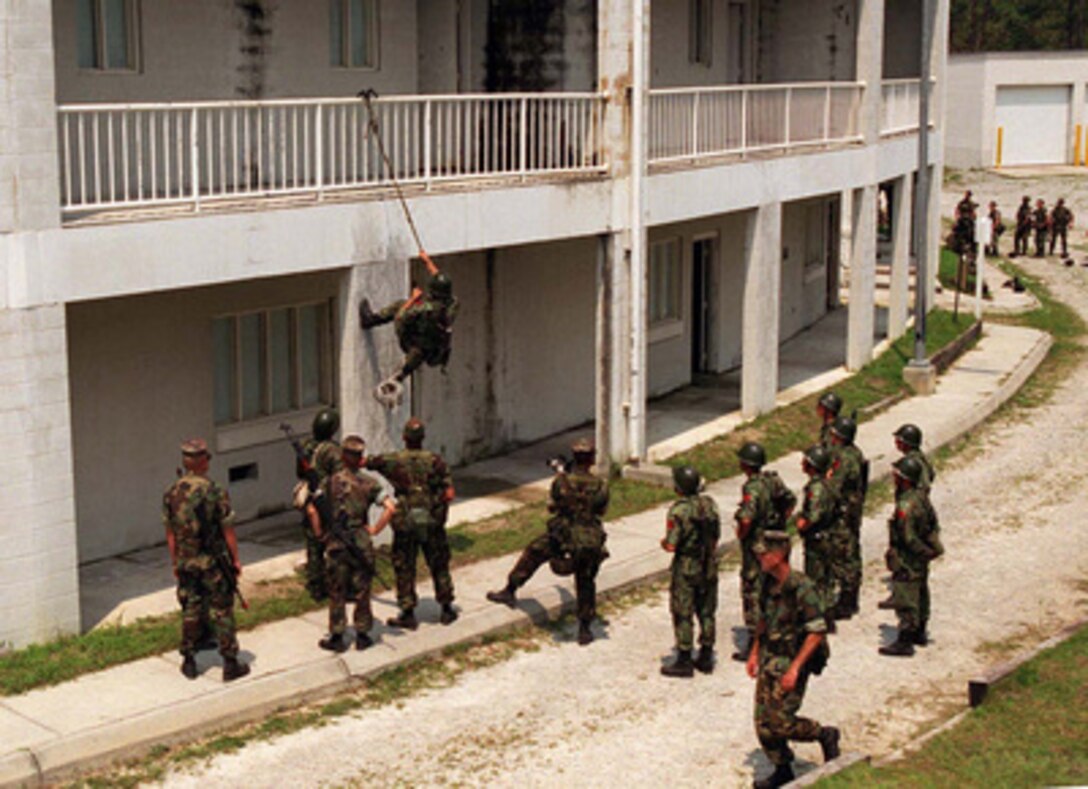 U.S. Marines instruct Albanian soldiers in the art of scaling buildings during a Military Operations in Urban Terrain Situational Training Exercise at Camp Lejeune, N.C., on Aug. 17, 1996 as part of Cooperative Osprey '96. Cooperative Osprey '96 is a NATO sponsored exercise as part of the alliance's Partnership for Peace program. The aim of the exercise is to develop interoperability among the participating forces through practice in combined peacekeeping and humanitarian operations. Three NATO countries and 16 Partnership for Peace nations are taking part in the field training exercise. The Marines are attached to the 2nd Battalion, 6th Marines. 