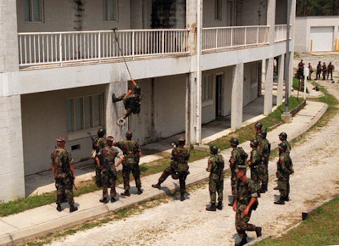 U.S. Marines instruct Albanian soldiers in the art of scaling buildings during a Military Operations in Urban Terrain Situational Training Exercise at Camp Lejeune, N.C., on Aug. 17, 1996 as part of Cooperative Osprey '96. Cooperative Osprey '96 is a NATO sponsored exercise as part of the alliance's Partnership for Peace program. The aim of the exercise is to develop interoperability among the participating forces through practice in combined peacekeeping and humanitarian operations. Three NATO countries and 16 Partnership for Peace nations are taking part in the field training exercise. The Marines are attached to the 2nd Battalion, 6th Marines. 