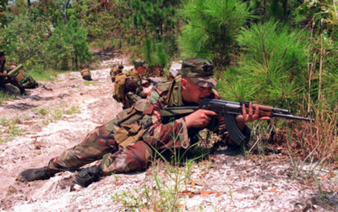 A Latvian soldier sights in his weapon while performing patrolling techniques learned during a Situational Training Exercise at Camp Lejeune, N.C., on Aug. 16, 1996 as part of Cooperative Osprey '96. Cooperative Osprey '96 is a NATO sponsored exercise as part of the alliance's Partnership for Peace program. The aim of the exercise is to develop interoperability among the participating forces through practice in combined peacekeeping and humanitarian operations. Three NATO countries and 16 Partnership for Peace nations are taking part in the field training exercise. 