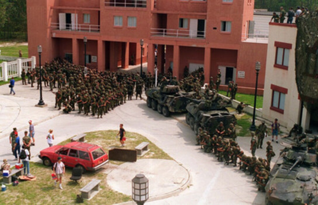 Canadian, Central Asian and Hungarian troops take charge of a simulated city during a Military Operations in Urban Terrain, Security and Civil Disturbance Operations Situational Training Exercise at Camp Lejeune, N.C., on Aug. 24, 1996 as part of Cooperative Osprey '96. Cooperative Osprey '96 is a NATO sponsored exercise as part of the alliance's Partnership for Peace program. The aim of the exercise is to develop interoperability among the participating forces through practice in combined peacekeeping and humanitarian operations. Three NATO countries and 16 Partnership for Peace nations are taking part in the field training exercise. 