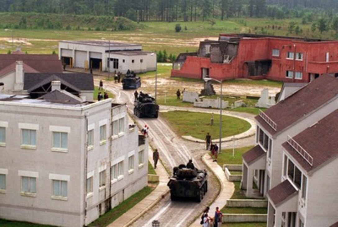 Light Armored Vehicles proceed through the town during a final training exercise in the Military Operations in Urban Terrain facility at Camp Lejeune, N.C., on Aug. 26, 1996, as part of Cooperative Osprey '96. Cooperative Osprey '96 is a NATO sponsored exercise as part of the alliance's Partnership for Peace program. The aim of the exercise is to develop interoperability among the participating forces through practice in combined peacekeeping and humanitarian operations. Three NATO countries and 16 Partnership for Peace nations are taking part in the field training exercise. 