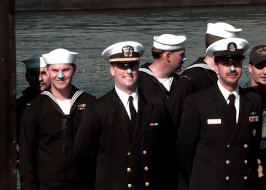 Crew members on board the U.S. Navy's nuclear fast-attack submarine USS Pogy (SSN 647) sport traditional Blue Noses as they return to their home port of San Diego, Calif., on Nov. 26, 1996. The Pogy and her crew spent 50 days underneath the Arctic ice cap during a 93-day deployment called Scientific Exercise '96. Seven scientists and technical advisors conducted experiments and collected samples for studies in water mass properties, geophysics, ice mechanics and pollution detection in the Arctic Ocean. The research voyage was the second of five planned deployments through the year 2000. 