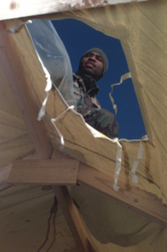 A U.S. Air Force Red Horse engineer lays down a plastic liner over the top of the inner liner of a tent being erected at Tuzla Air Base, Bosnia and Herzegovina, on Feb. 1, 1996, during Operation Joint Endeavor. The engineers, from the 823rd Civil Engineering Squadron, Hurlburt Field, Fla., are building a self-contained tent city known as Force Provider. The Force Provider will house troops deployed to Bosnia and Herzegovina as part of the NATO Implementation Force (IFOR). 