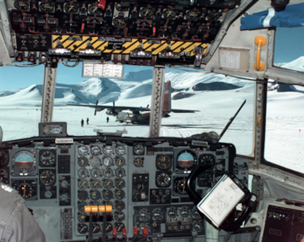 A U.S. Navy LC-130 Hercules ski-equipped cargo plane is visible from the cockpit of another Hercules as the aircraft prepares to take off from a remote National Science Foundation field camp on Shackleton Glacier, Antarctica on Jan. 22, 1996. The Shackleton Glacier Field Camp is one of the largest outlying research field camps the National Science Foundation operates during the Antarctic research summer between October and January. The National Science Foundation, U.S. Navy, Air Force, Coast Guard and Army work together to support scientific research year round. 