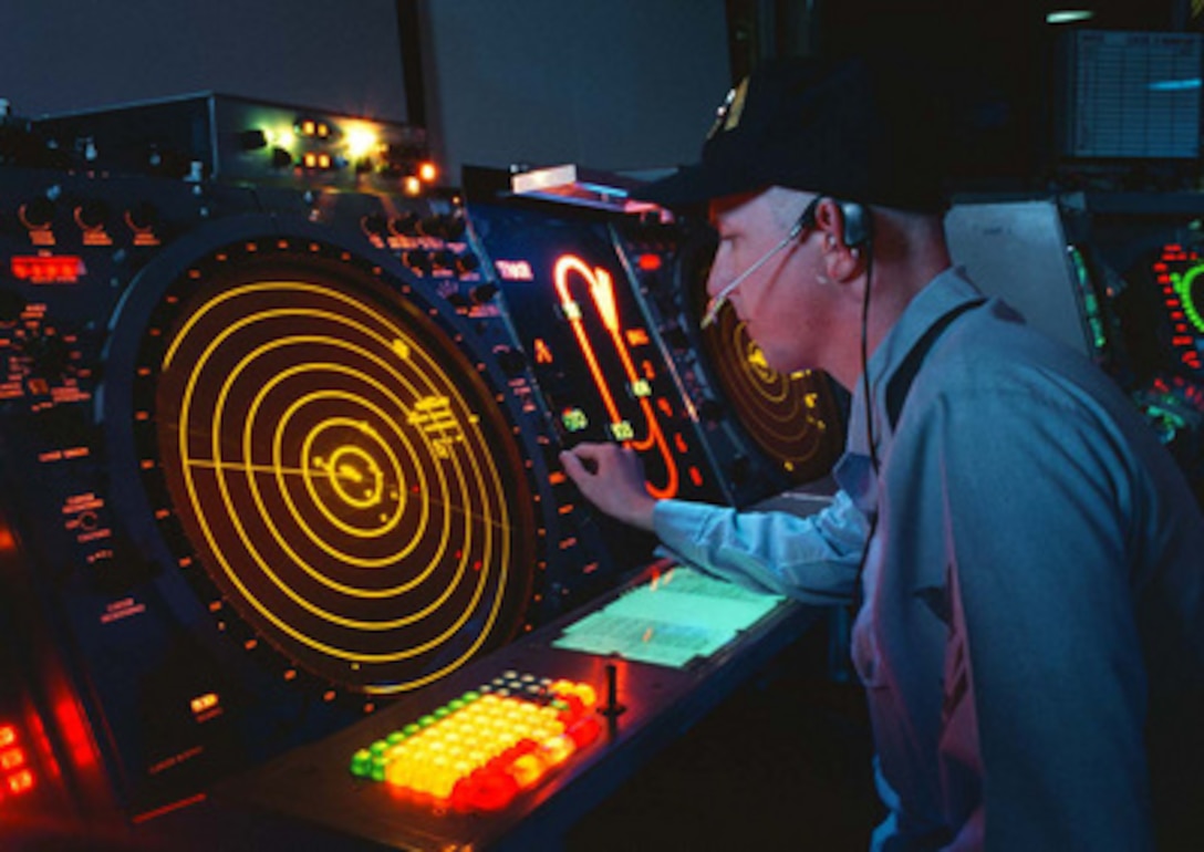A U.S. Navy air traffic controller watches his radar scope where he works as an Aircraft Approach Controller in the Carrier Air Traffic Control Center on board the USS George Washington (CVN 73) on Jan. 30, 1996. The controller is responsible for ensuring the safe, orderly and expeditious flow of air traffic operating in the vicinity of the aircraft carrier. The nuclear powered aircraft carrier and its battle group are en route to the Mediterranean Sea for a scheduled six-month deployment. While there, they will patrol the waters of the Adriatic Sea in support of the NATO Implementation Force (IFOR) in Operation Joint Endeavor. 