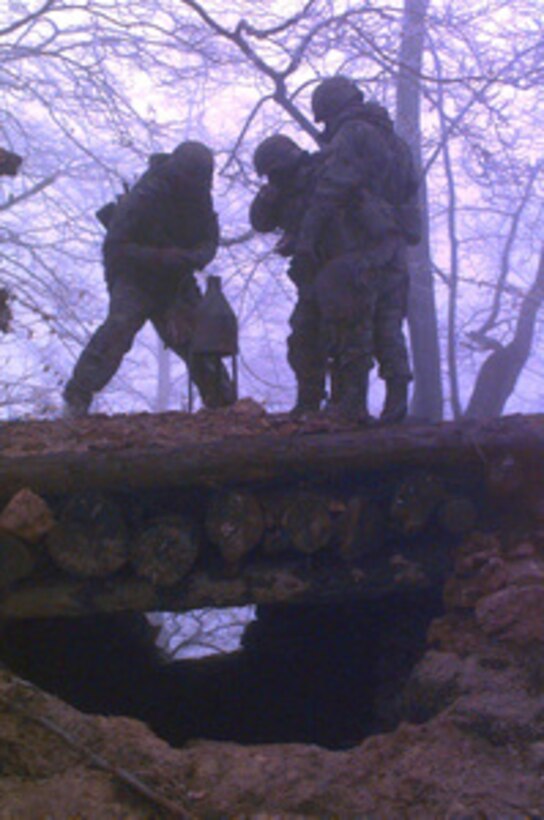 U.S. Army combat engineers set up a 40 lb. shape charge to blow up a prohibited Serbian bunker in the Zone of Separation in Bosnia and Herzegovina on Jan. 29, 1996, during Operation Joint Endeavor. The engineers are from 40th Engineers, 2nd Brigade, 1st Armored Division, Baumholder, Germany. The engineers are part of the NATO Implementation Force (IFOR). 