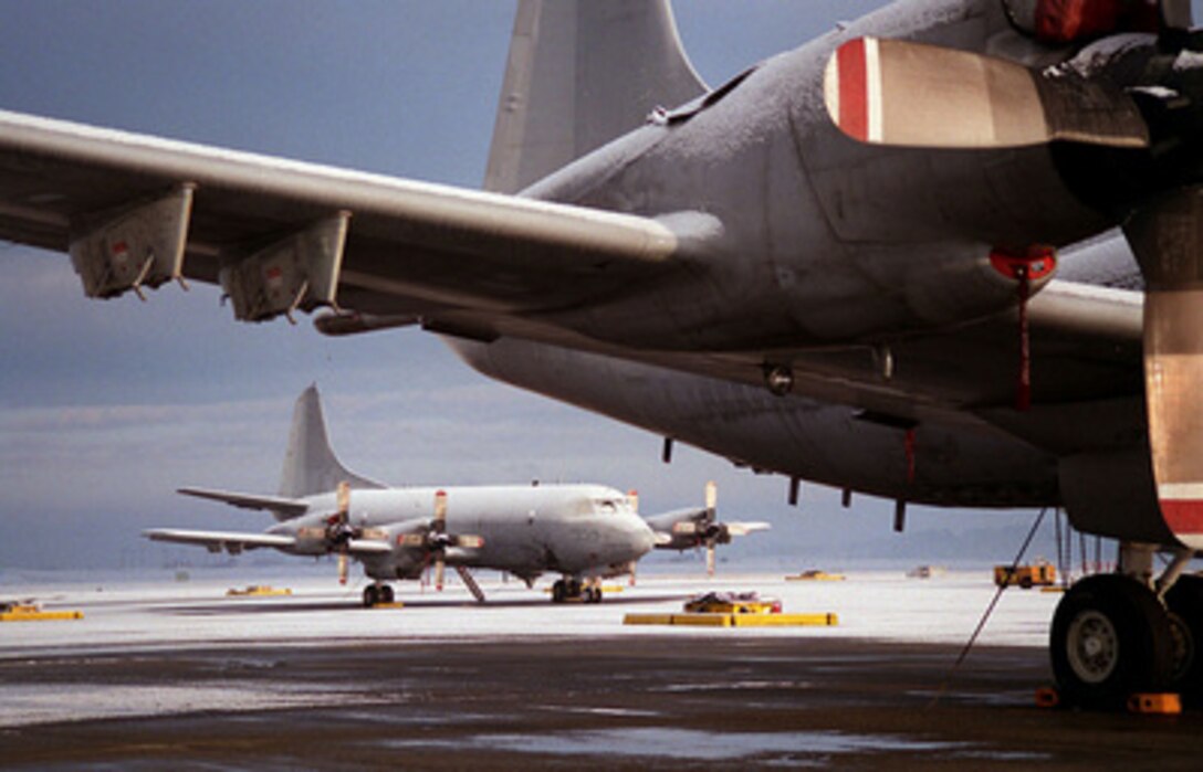 A dusting of early morning snow covers two U.S. Navy P-3C Orion aircraft from Patrol Squadron 46 on the flight line at Naval Air Station, Whidbey Island, Wash., on Jan. 26, 1996. The Orion is a land-based, long range, anti-submarine warfare patrol and surface surveillance aircraft. It has advanced submarine detection sensors such as directional frequency and ranging sonobouys and magnetic anomaly detection equipment. 