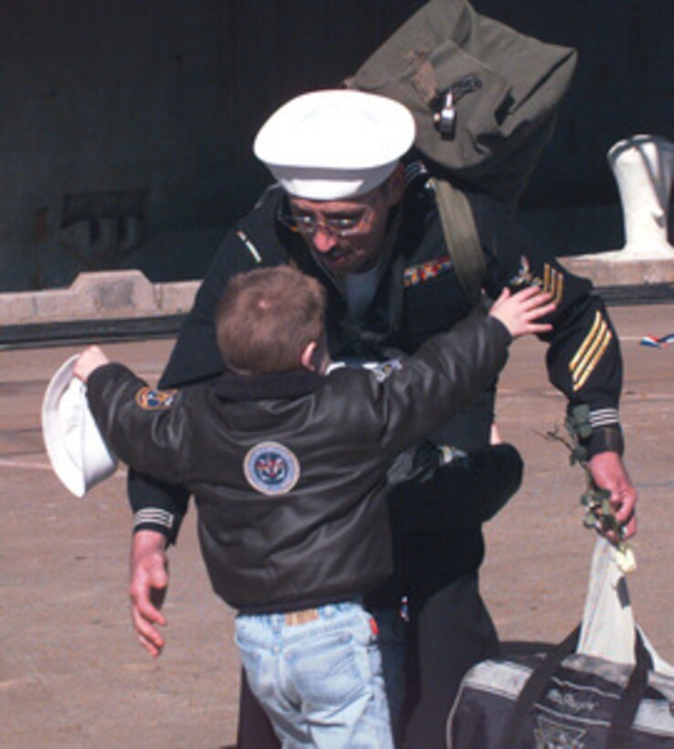 Christopher Morris runs to greet his father Petty Officer 1st Class Morris in Norfolk, Va., when the Navy Storekeeper's ship the aircraft carrier USS America (CV 66) returned from a six month, Mediterranean Sea deployment on Jan. 24, 1996. Additionally, the America Battle Group operated in the Adriatic Sea in support of the NATO Implementation Force (IFOR) in Bosnia and Herzegovina for Operation Joint Endeavor. This was the last deployment for the USS America which is scheduled for decommissioning later this year. 
