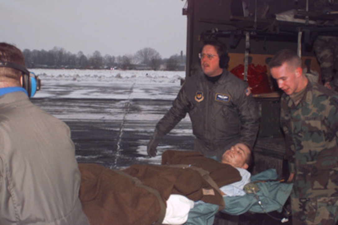 U.S. Army Spc. Martin Begosh is loaded into a U.S. Air Force C-130 Hercules for medical evacuation from Taszar, Hungary, on Jan. 3, 1996. Begosh was wounded Dec. 30 when the Humvee he was driving on patrol struck a land mine in northern Bosnia and Herzegovina. Begosh is a military policeman with the 709th Military Police Battalion, Hanau Army Post, Germany. He is being evacuated from Taszar by the U.S. Air Force 86th Aeromedical Evacuation Squadron at Ramstein Air Base, Germany. Begosh is the first soldier wounded in the NATO Operation Joint Endeavor. 