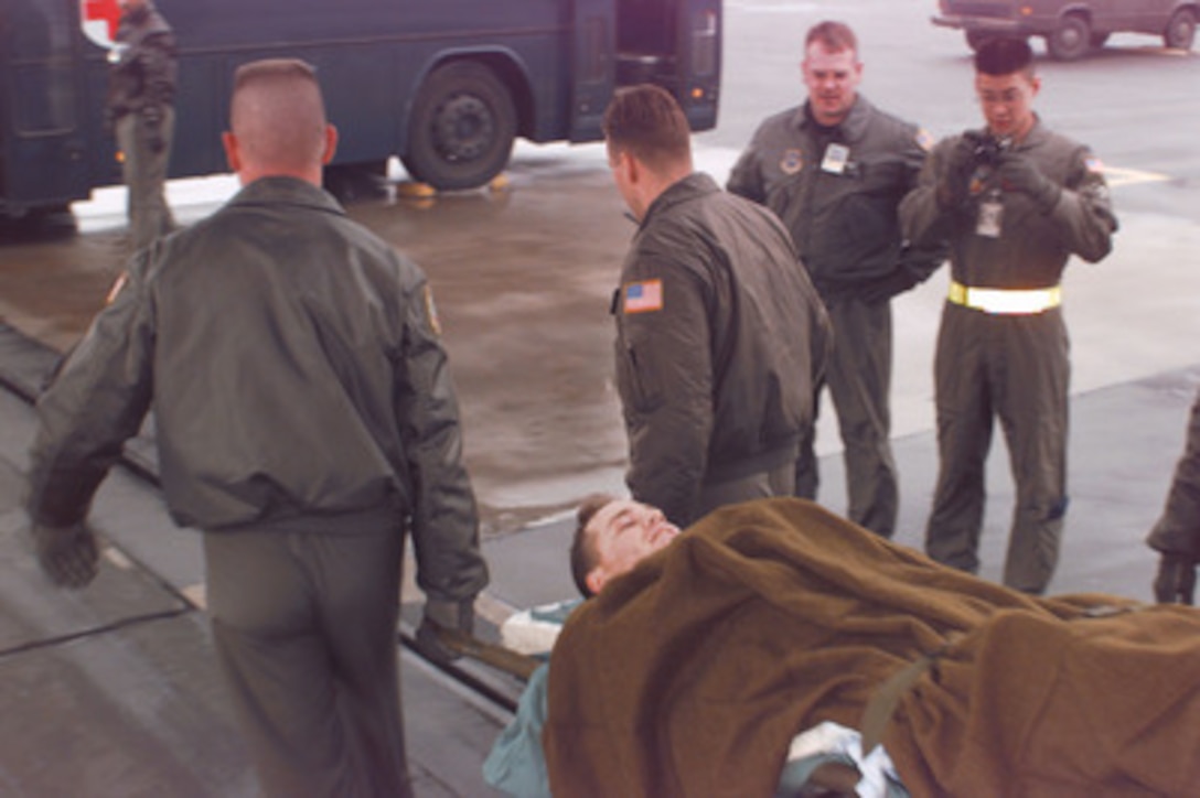 U.S. Army Spc. Martin Begosh is carried from a U.S. Air Force C-130 Hercules at Ramstein Air Base, Germany, after being evacuated from Taszar, Hungary, on Jan. 3, 1996. Begosh was wounded Dec. 30 when the Humvee he was driving on patrol struck a land mine in northern Bosnia and Herzegovina. Begosh is a military policeman with the 709th Military Police Battalion, Hanau Army Post, Germany. He was evacuated from Taszar by the U.S. Air Force 86th Aeromedical Evacuation Squadron at Ramstein Air Base, Germany. Begosh is the first soldier wounded in the NATO Operation Joint Endeavor. 