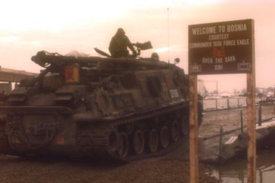 A U.S. Army M-88A 1 Recovery Vehicle drives onto the U.S. Army bridge over the Sava River from Zupania, Croatia, into Bosnia and Herzegovina on Dec. 31, 1995. U.S. Army engineers overcame freezing temperatures, unusual flooding, and other logistical challenges to build the 2,033 foot long bridge, which is longer than the Brooklyn Bridge. The bridge has become one of the primary routes for the NATO Implementation Force (IFOR) deployment into Bosnia and Herzegovina for Operation Joint Endeavor. 