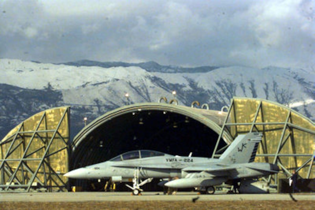 A U.S. Marine Corps F/A-18 Hornet sits on the ramp at Aviano Air Base, Italy, as it is prepared for a mission over Bosnia and Herzegovina on Dec. 28, 1995. The Hornet's mission is in support of the NATO Implementation Force (IFOR) in Operation Joint Endeavor. The all weather, fighter and attack aircraft is one of 12 Hornets deployed to Aviano from Fighter Attack (All Weather) Squadron 224 of Beaufort, S.C. 