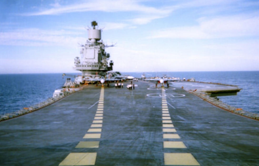 Visiting U.S. Navy officers tour the flight deck of the Russian Aircraft Carrier Adm. Kuznetsov as it steamed in the Mediterranean Sea on Jan. 7, 1996. As seen from the bow ramp, the aircraft carrier became the meeting place for the First Deputy Commander of the Russian Navy and the Commander of the U.S. Navy's Sixth Fleet. Russian Adm. Igor Kasatonov invited Vice Adm. Donald L. Pilling, U.S. Navy, aboard the Russian carrier to discuss potential professional contacts between the two navies during the Adm. Kuznetsov deployment in the Mediterranean. During the tour, the American delegation was hosted to a traditional Russian meal and a display of embarked aircraft. The Russian carrier is in the Mediterranean to show the flag and help commemorate the Russian Navy's 300th anniversary. 