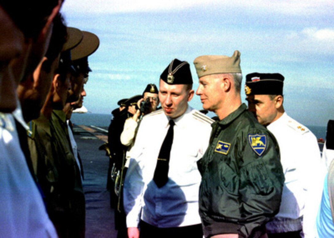 A Russian Navy officer introduces members of the crew of the Russian Aircraft Carrier Adm. Kuznetsov to Vice Adm. Donald L. Pilling, U.S. Navy, as the ship steamed in the Mediterranean Sea on Jan. 7, 1996. The aircraft carrier became the meeting place for the First Deputy Commander of the Russian Navy and the Commander of the U.S. Navy's Sixth Fleet. Russian Adm. Igor Kasatonov invited Vice Adm. Donald L. Pilling, U.S. Navy, aboard the Russian carrier to discuss potential professional contacts between the two navies during the Adm. Kuznetsov deployment in the Mediterranean. The American delegation was hosted to a tour of the ship, a display of embarked aircraft and a traditional Russian meal. The Russian carrier is in the Mediterranean to show the flag and help commemorate the Russian Navy's 300th anniversary. 