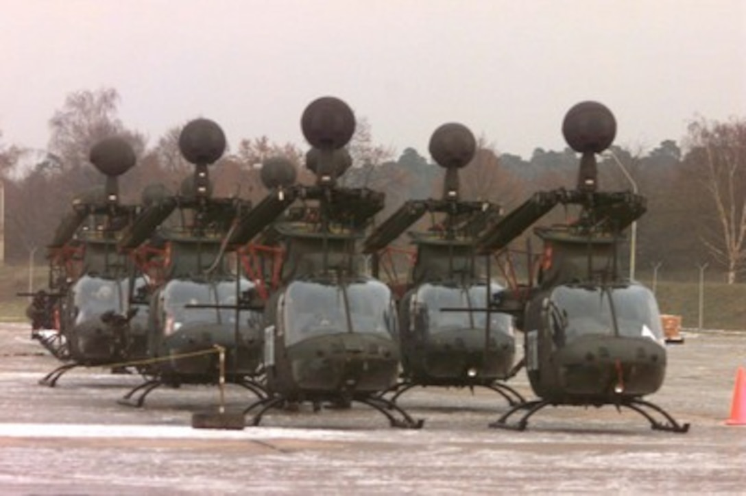 U.S. Army OH-58D Kiowa Warrior helicopters are staged for deployment in Operation Joint Endeavor at Rhein Main Air Base, Germany, on Jan. 3, 1996. The OH-58's will be loaded into Air Force cargo aircraft and deployed to bases in Bosnia and Herzegovina as part of the NATO Implementation Force (IFOR). The Kiowa is a two seat, single engine, four-bladed main rotor, scout helicopter with a low light television, thermal imaging system and a laser rangefinder/designator incorporated into a mast mounted sight. The helicopters are from the 3rd Battalion of the 4th Aviation Brigade Cavalry Unit, Schweifurt, Germany. 
