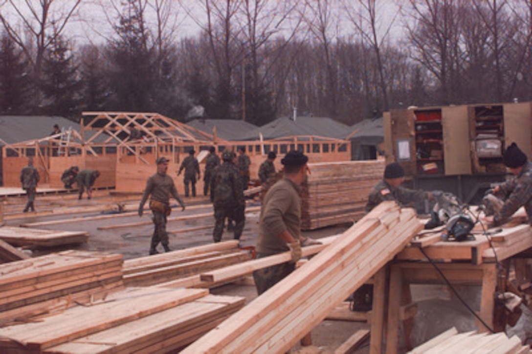 U.S. Air Force Red Horse engineers quickly erect a tent city at Tuzla Air Base, Bosnia and Herzegovina, on Dec. 31, 1995. The hard backed tents will be used to house U.S. Army and Air Force troops at Tuzla Air Base. The engineers are from the 823rd Red Horse Civil Engineering Squadron, Hurlburt Field, Fla. 