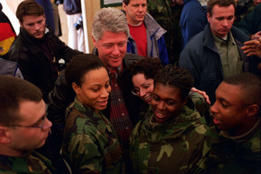 U.S. Army soldiers get in close for a photo with President Bill Clinton as he visits U.S. service men and women deployed to Hungary for Operation Joint Endeavor on Jan. 13, 1996. President Clinton will also meet with U.S. troops in Bosnia and Herzegovina and Croatia. 
