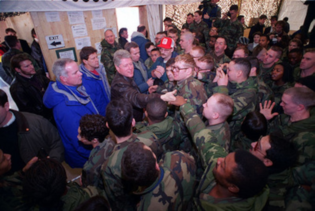 U.S. Army soldiers get in close to shake hands with President Bill Clinton as he visits U.S. service men and women deployed to Hungary for Operation Joint Endeavor on Jan. 13, 1996. President Clinton will also meet with U.S. troops in Bosnia and Herzegovina and Croatia. 