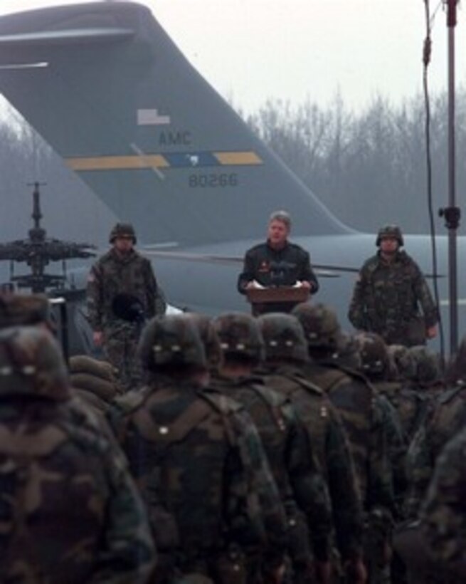 President Bill Clinton speaks to U.S. service men and women deployed to Tuzla Air Base, Bosnia and Herzegovina, on Jan. 13, 1996. President Clinton is visiting U.S. service men and women deployed to Bosnia and Herzegovina, Croatia and Hungary as part of the NATO Implementation Force (IFOR) in Operation Joint Endeavor. Nash is the Commander of the 1st Armored Division and Ground Forces Bosnia and Herzegovina. 