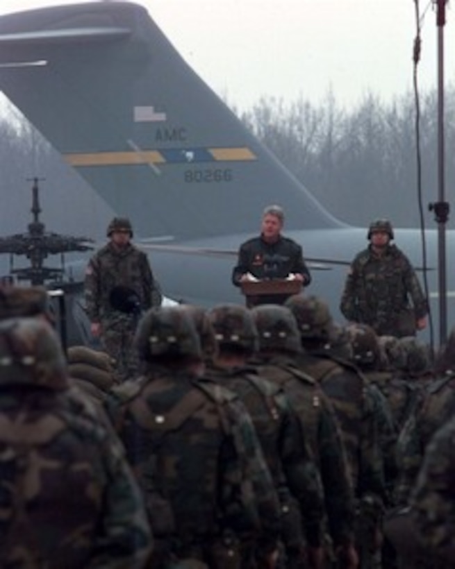 President Bill Clinton speaks to U.S. service men and women deployed to Tuzla Air Base, Bosnia and Herzegovina, on Jan. 13, 1996. President Clinton is visiting U.S. service men and women deployed to Bosnia and Herzegovina, Croatia and Hungary as part of the NATO Implementation Force (IFOR) in Operation Joint Endeavor. Nash is the Commander of the 1st Armored Division and Ground Forces Bosnia and Herzegovina. 