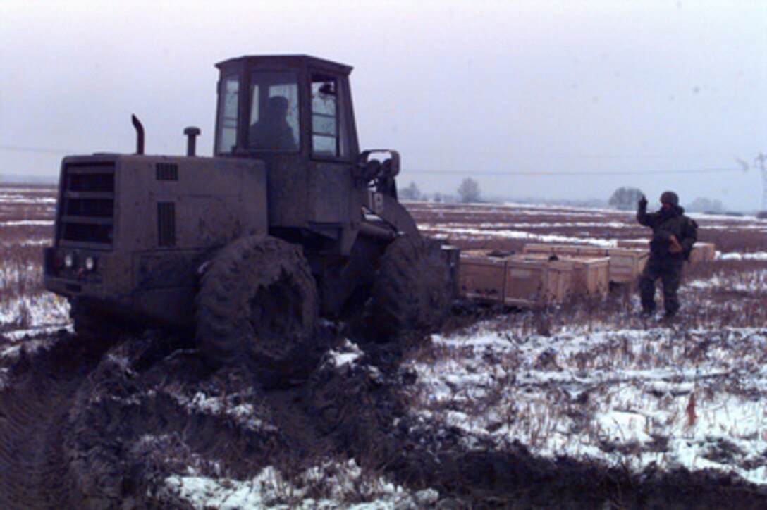U.S. Navy Seabees use a forklift to place crates of tents in a muddy field outside Zupanja, Croatia, on Jan. 4, 1996. The Seabees are in to Zupanja as part of the NATO Enabling Force of Operation Joint Endeavor. Enabling forces are moving into the Croatia, Bosnia and Herzegovina, and Slovenia theaters of operation to prepare entry points for the main Implementation Force (IFOR). The Seabees, deployed from Naval Mobile Construction Battalion 133, Gulfport, Miss., will construct housing facilities for 2,500 U.S. transient troops. 