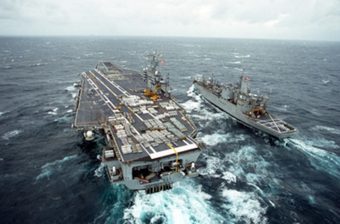 The U.S. Navy aircraft carrier USS Theodore Roosevelt (CVN 71) conducts a Vertical Replenishment weapons on-load with the ammunition ship USS Santa Barbara (AE 28) as they steam in the waters off the Virginia coast on Dec. 20, 1995. The crates of ordnance are being transferred from the Santa Barbara to the Roosevelt by using a CH-46 Sea Knight helicopter. 