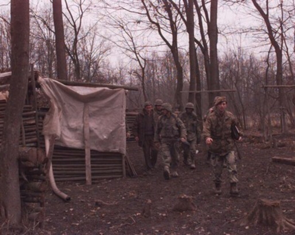 U.S. Army combat engineers follow Bosnian Serb Army Capt. Radovan Zoranovic as they inspect a Bosnian Serb bunker along the Zone of Separation in Bosnia and Herzegovina on Jan. 14, 1996. The U.S. soldiers are part of the NATO Implementation Force (IFOR) and are inspecting the bunkers and trenches along the Zone of Separation for prohibited weapons and munitions. The engineers are from the 16th Engineer Battalion, 130th Brigade, of Bamberg, Germany. Zoranovic is the commander of the 3rd Battalion, 2nd Brigade. 