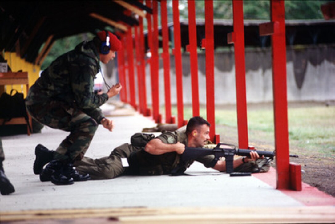 A member of the Canadian Combat Controller biathlon team clears his weapon after firing during the biathlon competition at Airlift Rodeo '96 on June 24, 1996. Airlift Rodeo '96 is the United States Transportation Command's tanker/airlift competition which tests the flight and ground skills of aircrews as well as the related skills of combat control, security police, aerial port, aeromedical evacuation, and maintenance team members. Crews from the U.S. and nine other countries are participating in the competition held this year at McChord Air Force Base, Wash. 